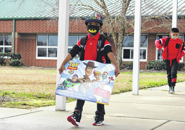 
			
				                                Wadesboro Primary School student returns from class with a gift after his first day back in-person on March 1. 
                                 Liz O’Connell | Anson Record

			
		
