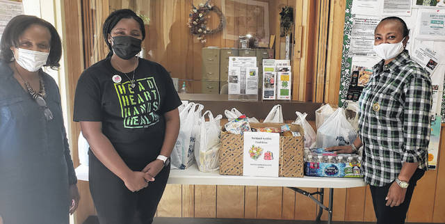 
			
				                                Photo courtesy of Roshunda Terry
                                Picture with the table of donated items is ( left to right): DSS Director Lula Jackson, 4-H Youth Promise Case Manager Raven Spencer and Administrative Officer Kishia Dunlap.
 
			
		