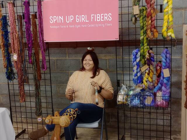 <p>Spin Up Girl Crystal Hesser, assures no one will fall asleep if they prick their finger on her spindle wheel! Hesser started out knitting but found her niche in spinning.</p>
                                 <p>Lauren Monica | Anson Record</p>